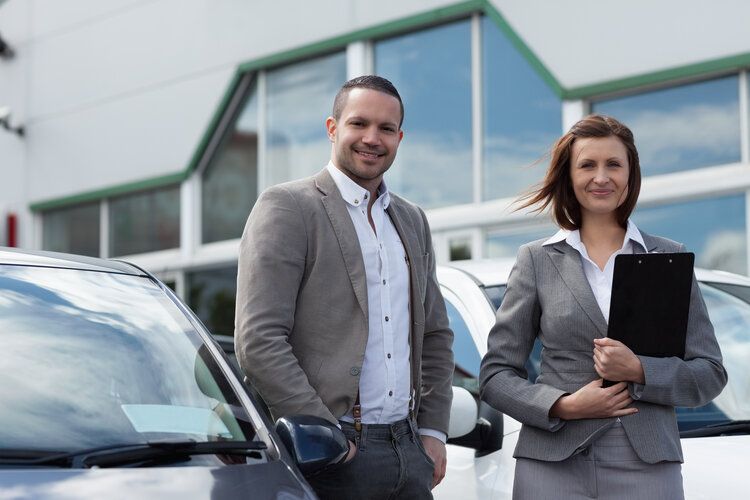 Agents posing outside in parking lot